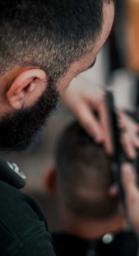 foto di un parrucchiere che taglia i capelli ad un altro uomo